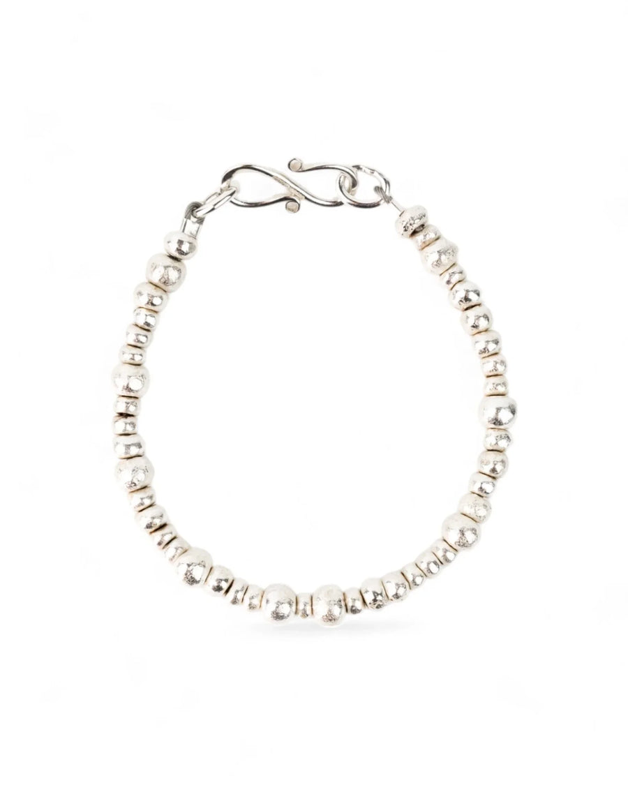 Handmade silver nugget bracelet with organic textured beads on a white background