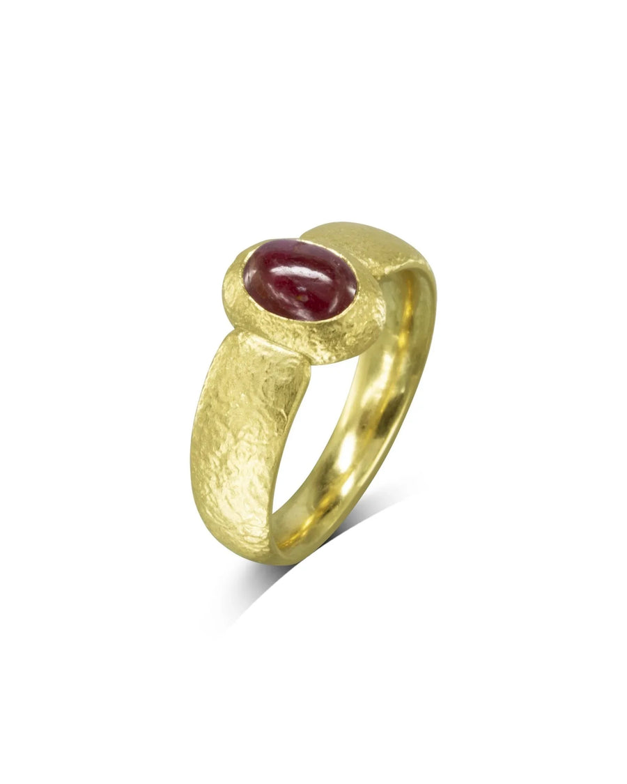 Textured yellow gold ring with an oval ruby gemstone.