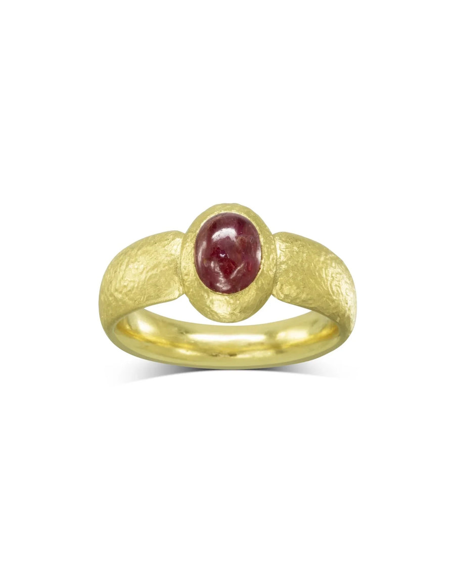 Yellow gold ring with a round, bezel-set ruby gemstone.
