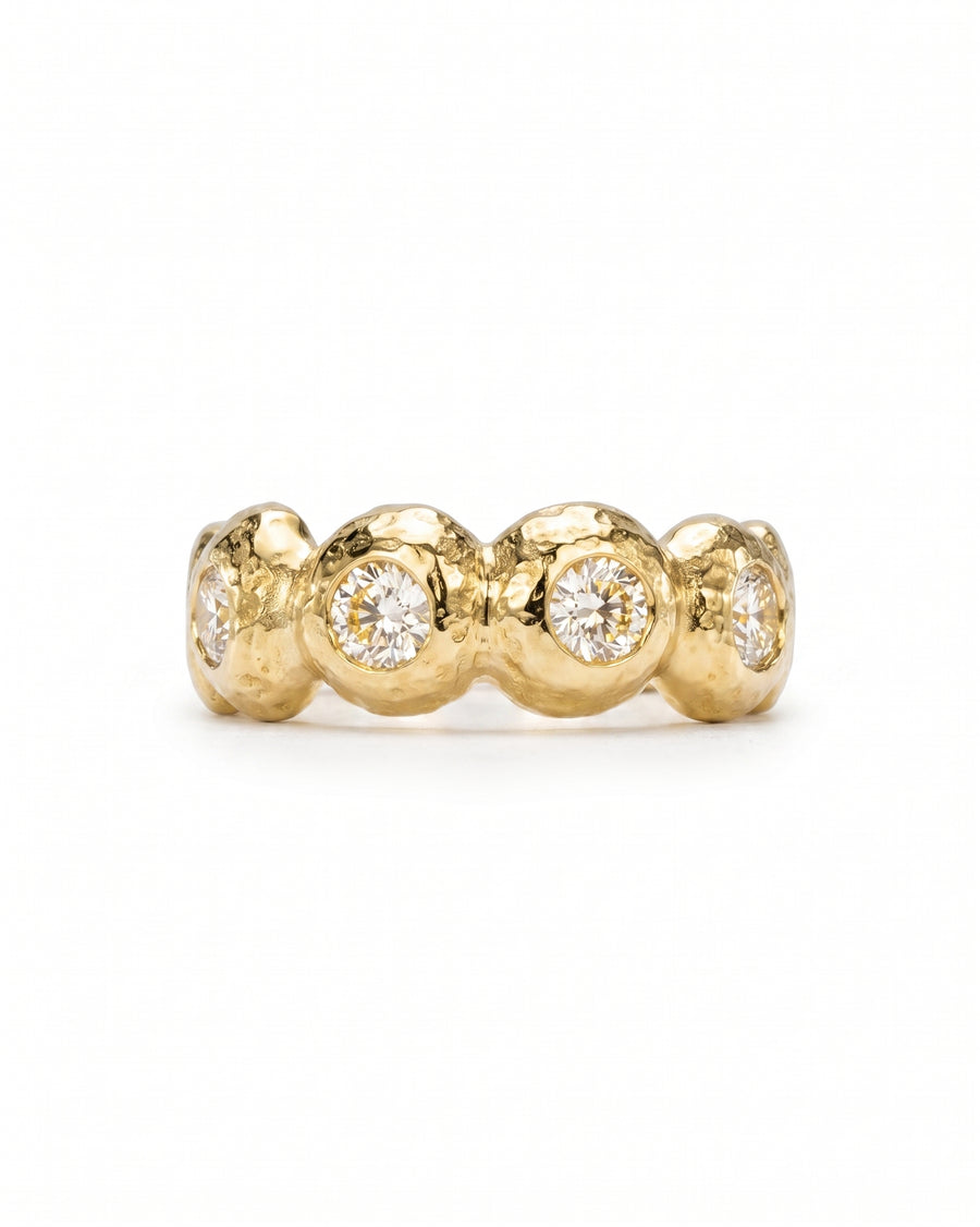 Nugget yellow gold eternity ring with five bezel-set diamonds.