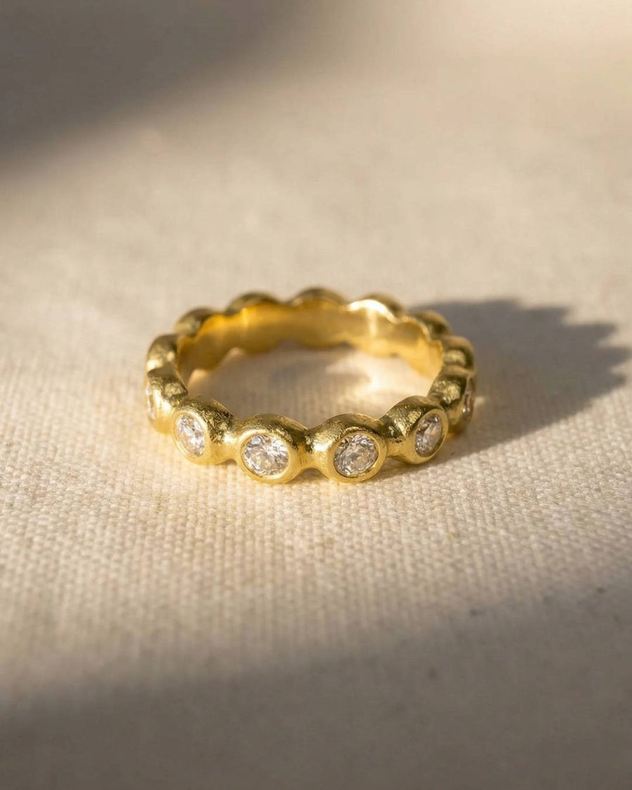 Nugget yellow gold diamond full eternity ring with bezel-set diamonds.