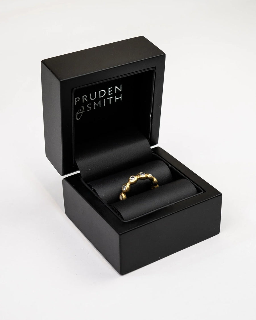 Yellow gold diamond ring with a nugget design, 4mm, in a black box.
