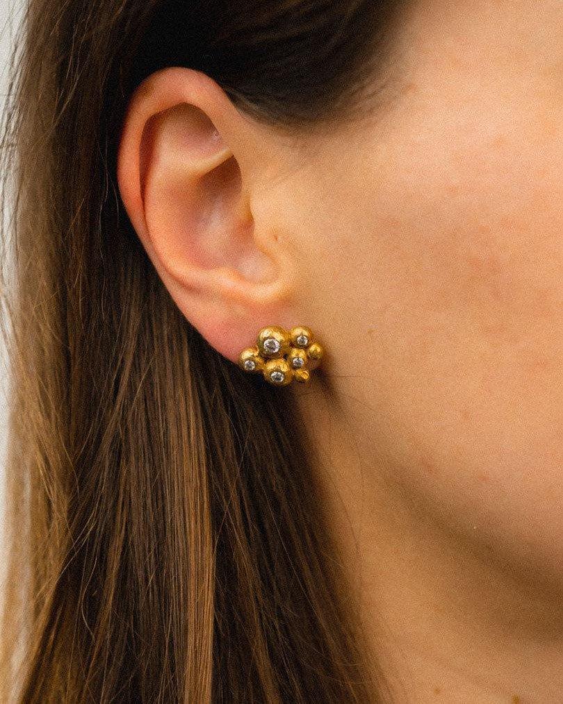 Gold cluster stud earring with small gemstones worn on ear, organic luxury jewellery design