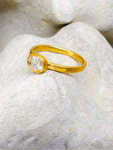 Gold and diamond ring with stone background