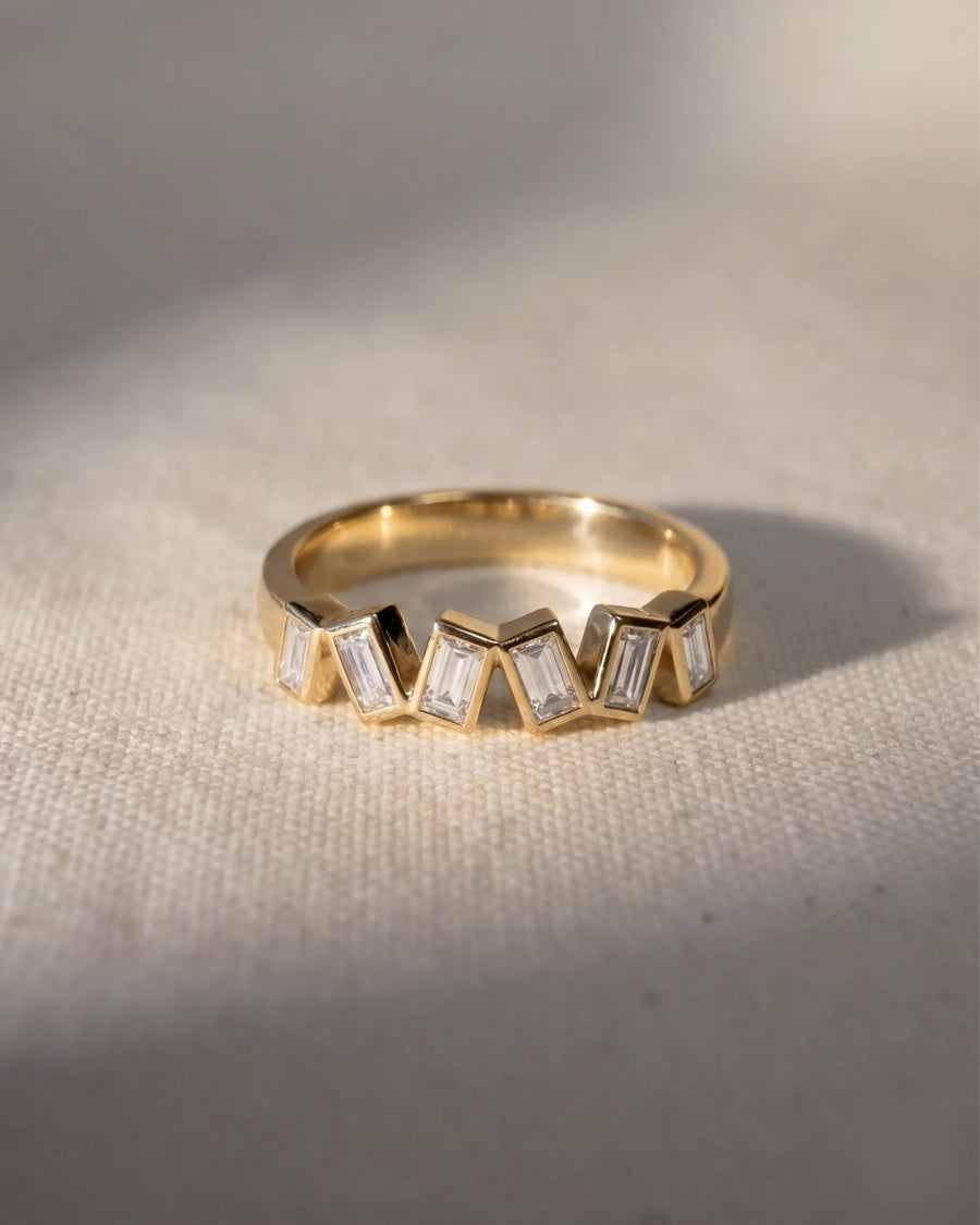 18ct yellow gold half eternity ring with offset baguette diamonds.