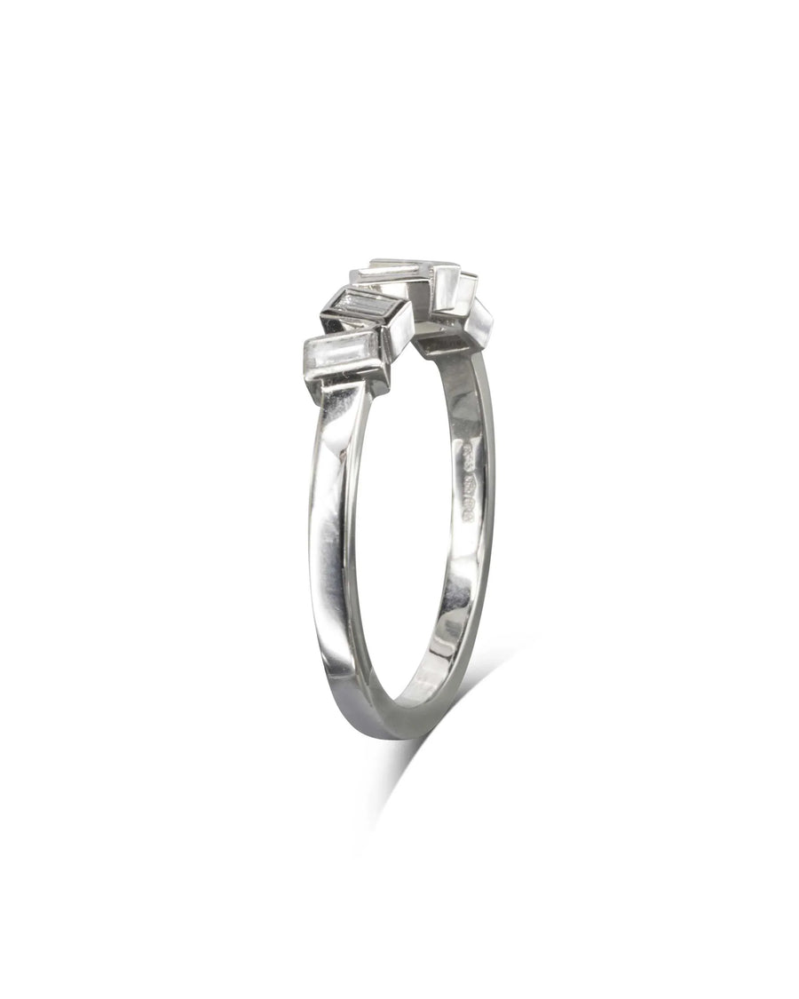 Silver half eternity ring with offset baguette diamonds.