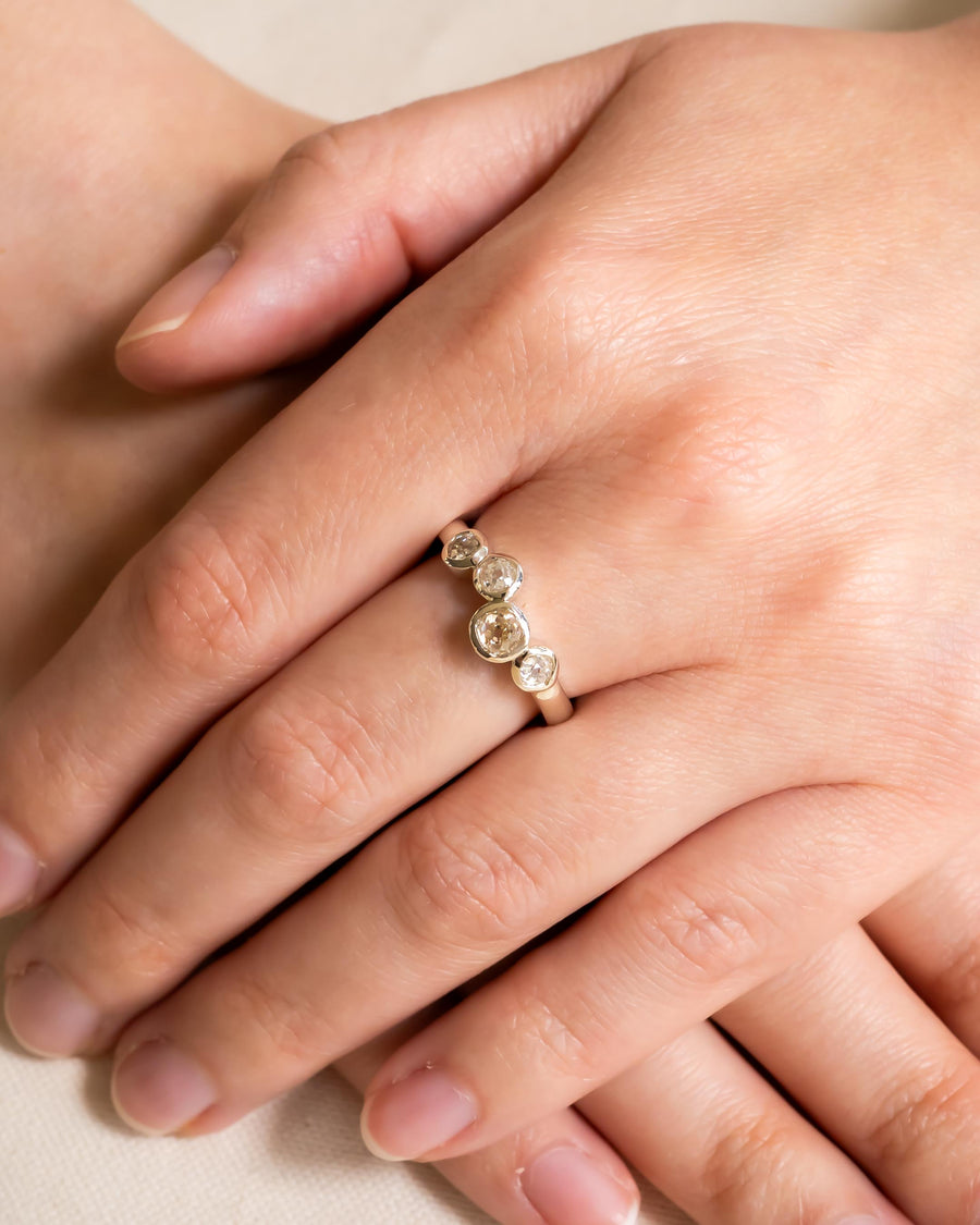 Platinum engagement ring with offset old cut diamonds.