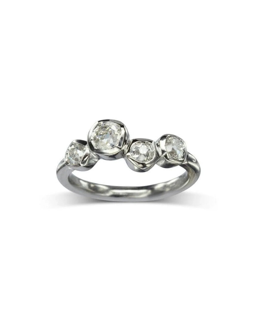 Platinum engagement ring with four offset old cut diamonds.