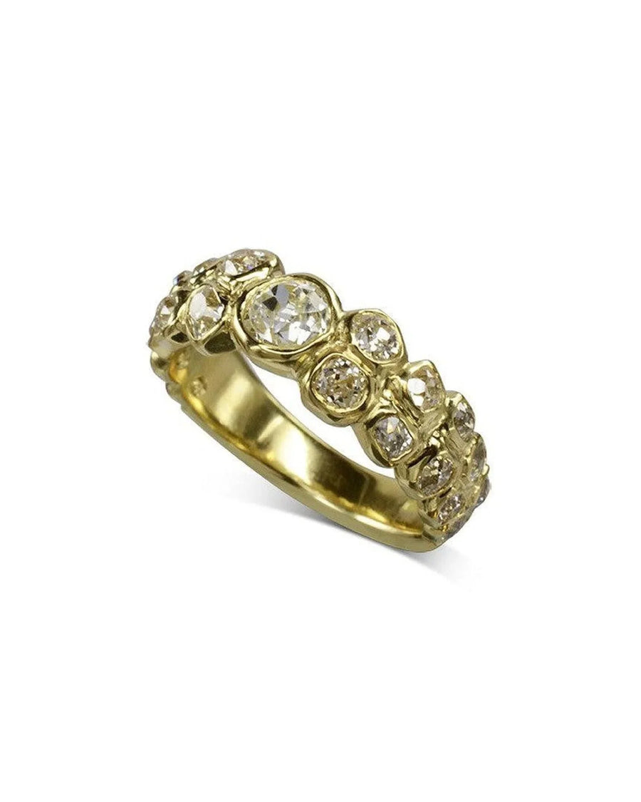 Yellow gold eternity ring with old cut diamonds in varied sizes.