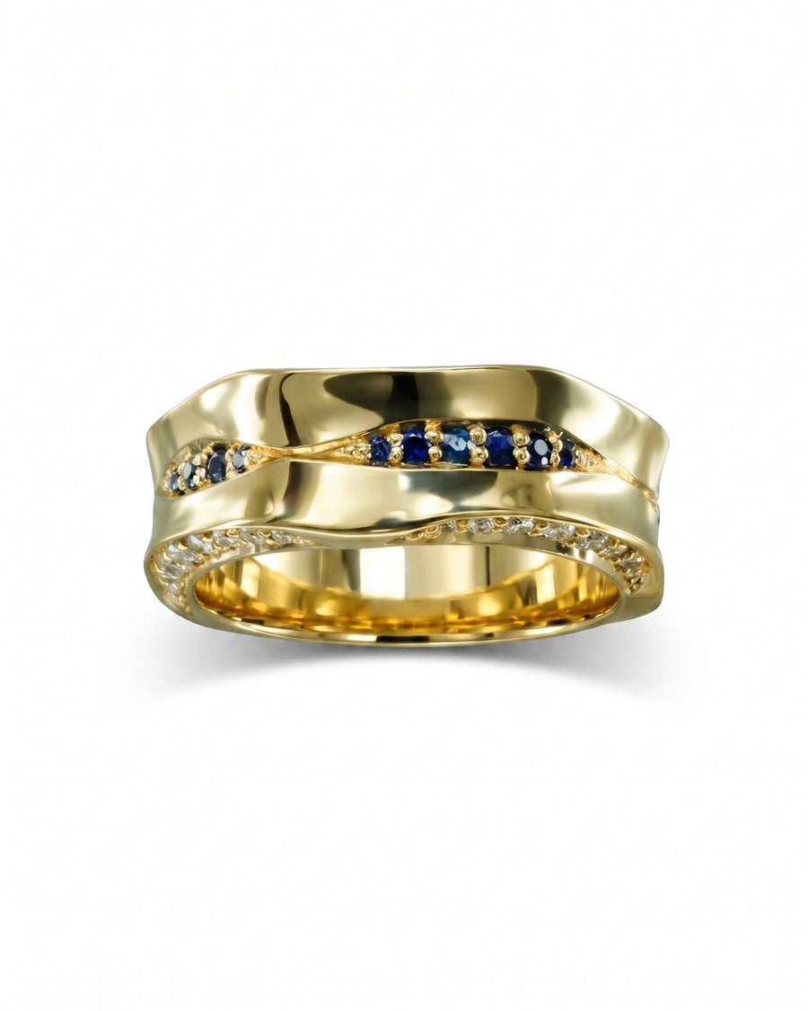 Gold eternity ring with wavy design, blue sapphires, and diamonds.