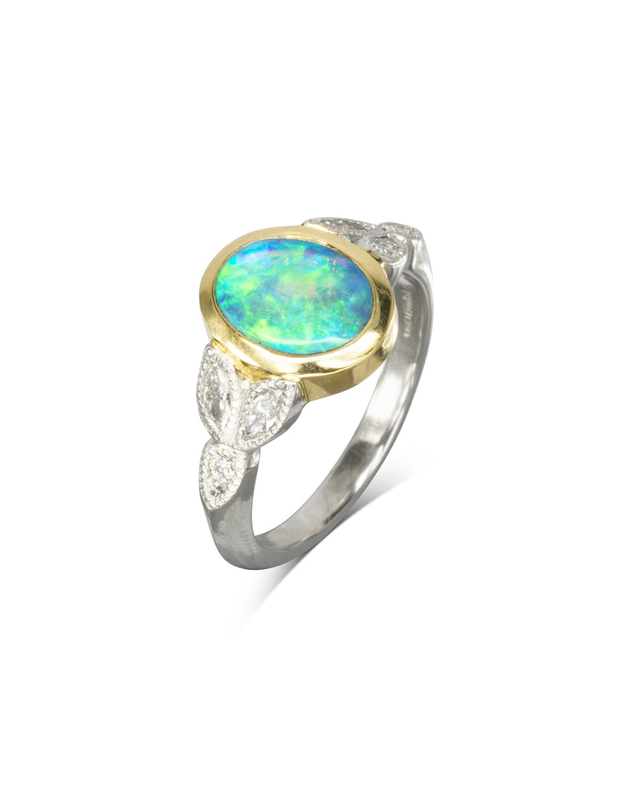 Silver and gold ring with an oval green opal and marquise diamonds.