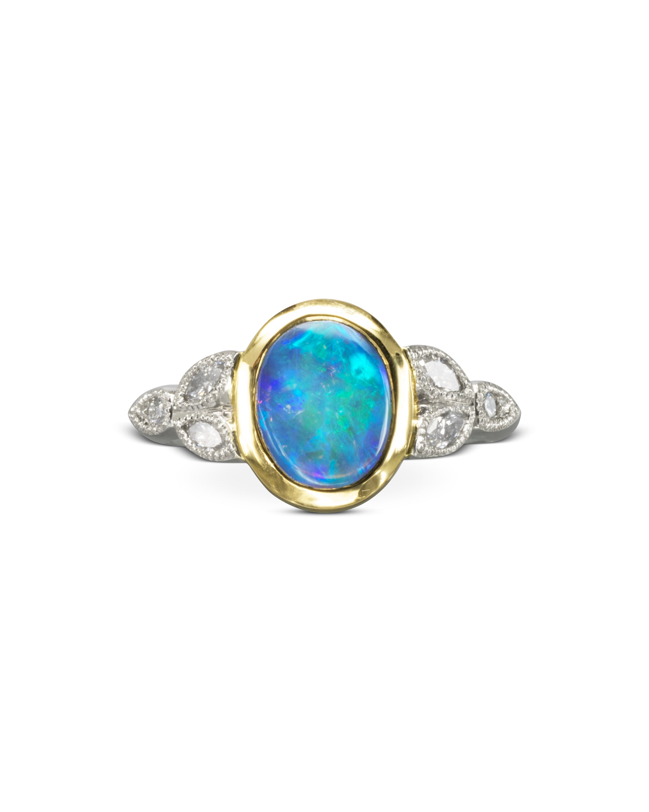 Gold and silver ring with an oval blue opal and diamond accents.