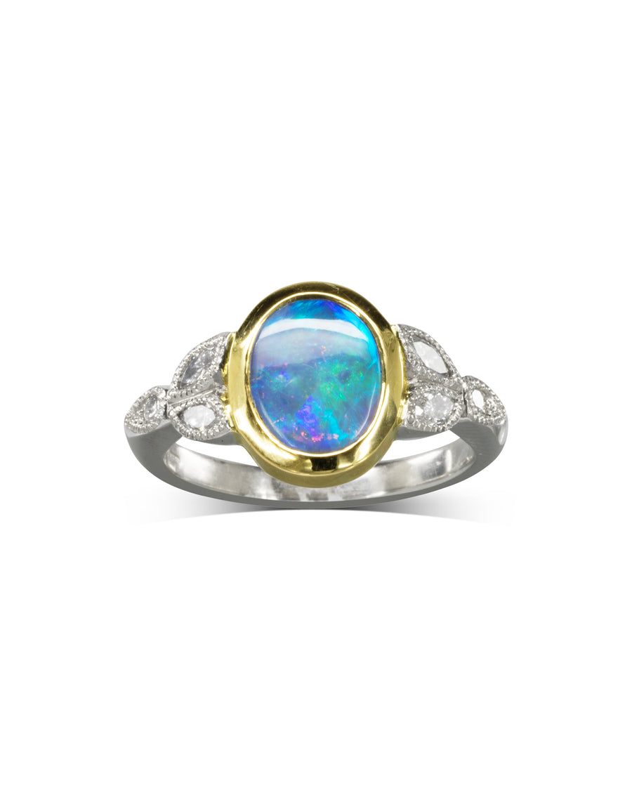 Gold and silver vintage ring with an oval opal and diamond accents.