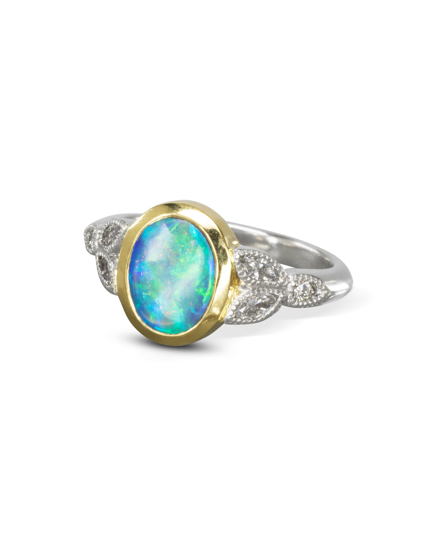 Vintage gold and silver ring with an oval opal and diamond accents.