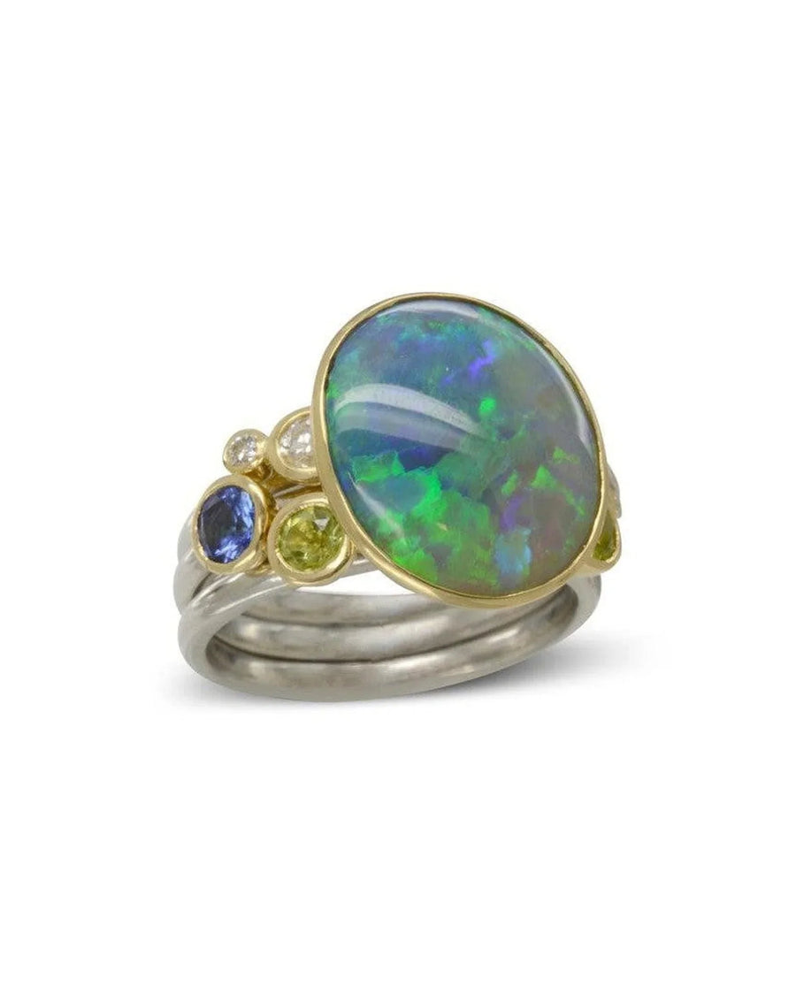 Opal and yellow gold stacking ring set with colorful gemstones on silver bands