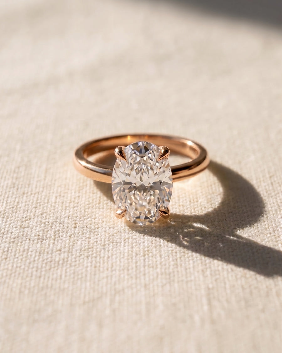 18ct rose gold solitaire engagement ring with an oval diamond.