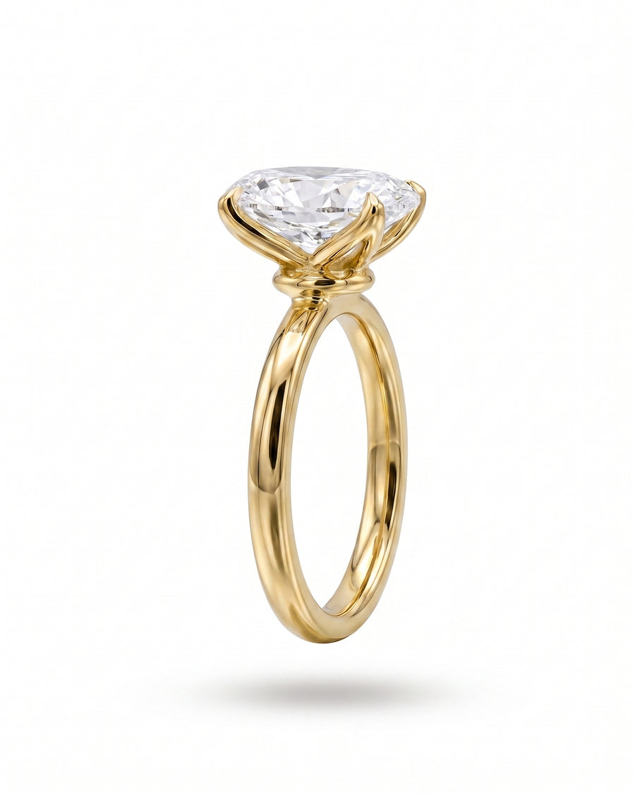 Yellow gold solitaire engagement ring with an oval diamond.