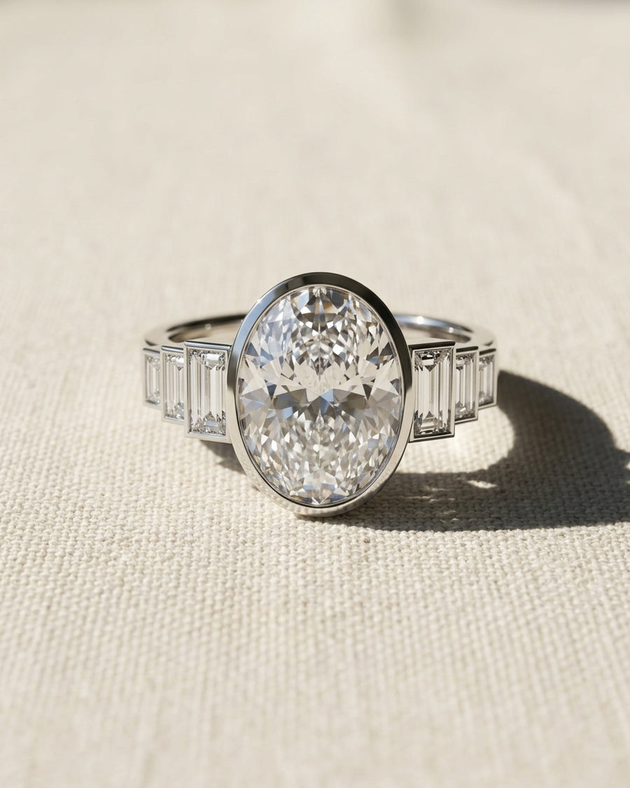 Platinum oval cut lab grown diamond engagement ring with baguette side stones.