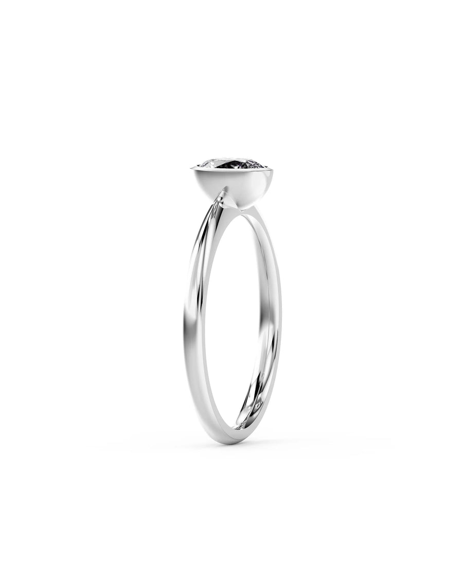 Silver oval cut bezel engagement ring with a diamond.