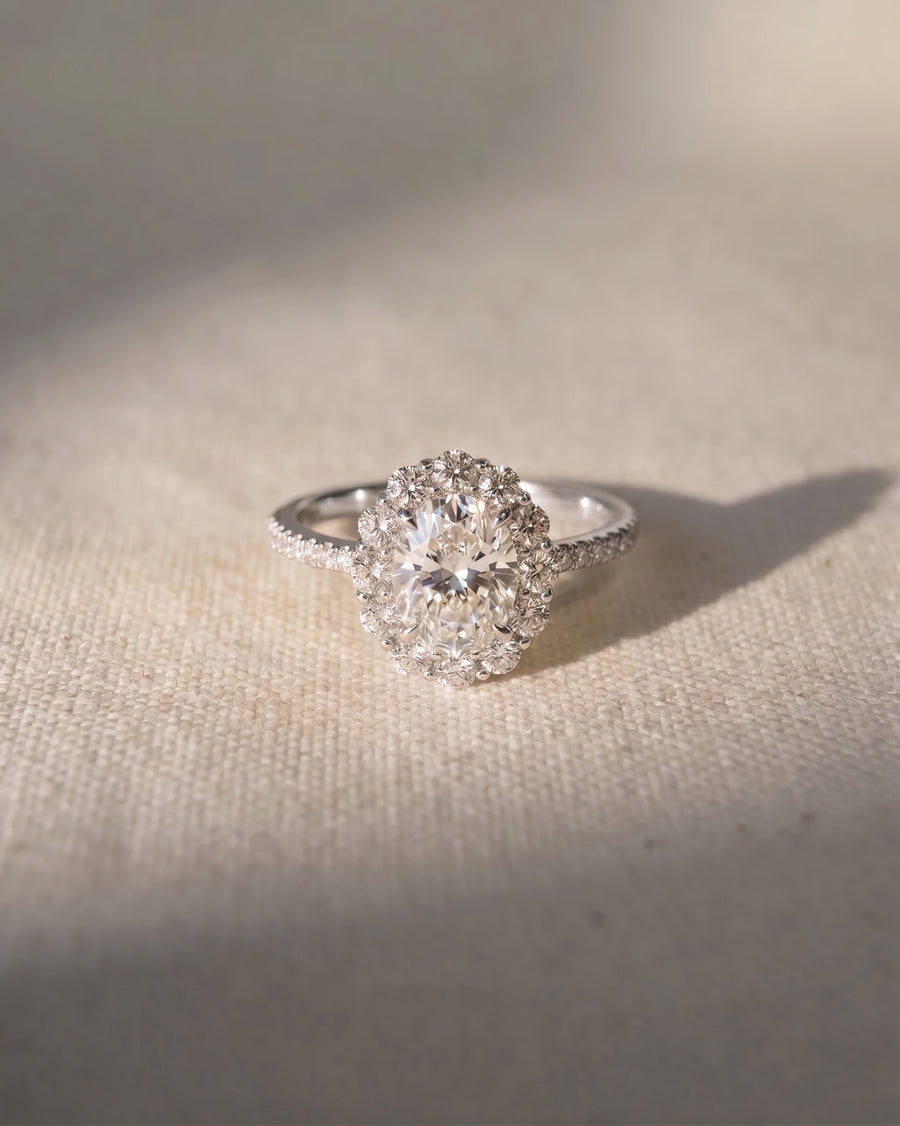 Platinum oval cut claw set halo ring with lab grown diamonds.