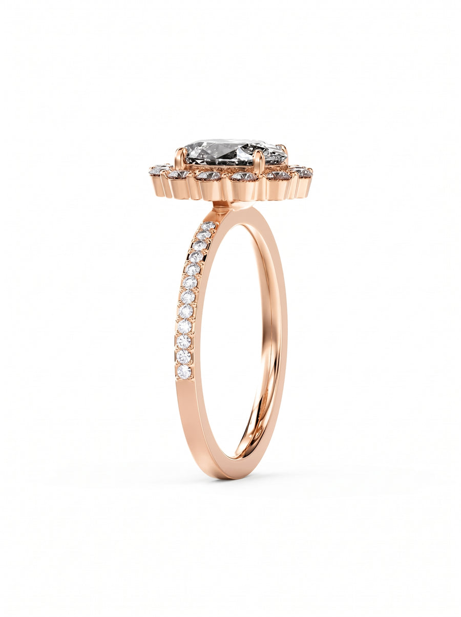 Rose gold oval cut diamond halo ring with a pavé diamond band on a white background.