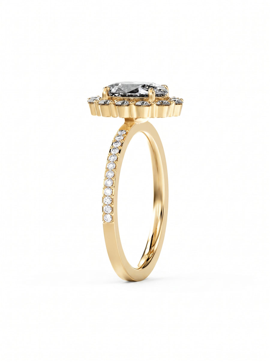 Oval cut diamond ring in yellow gold with a claw set halo and pavé band.