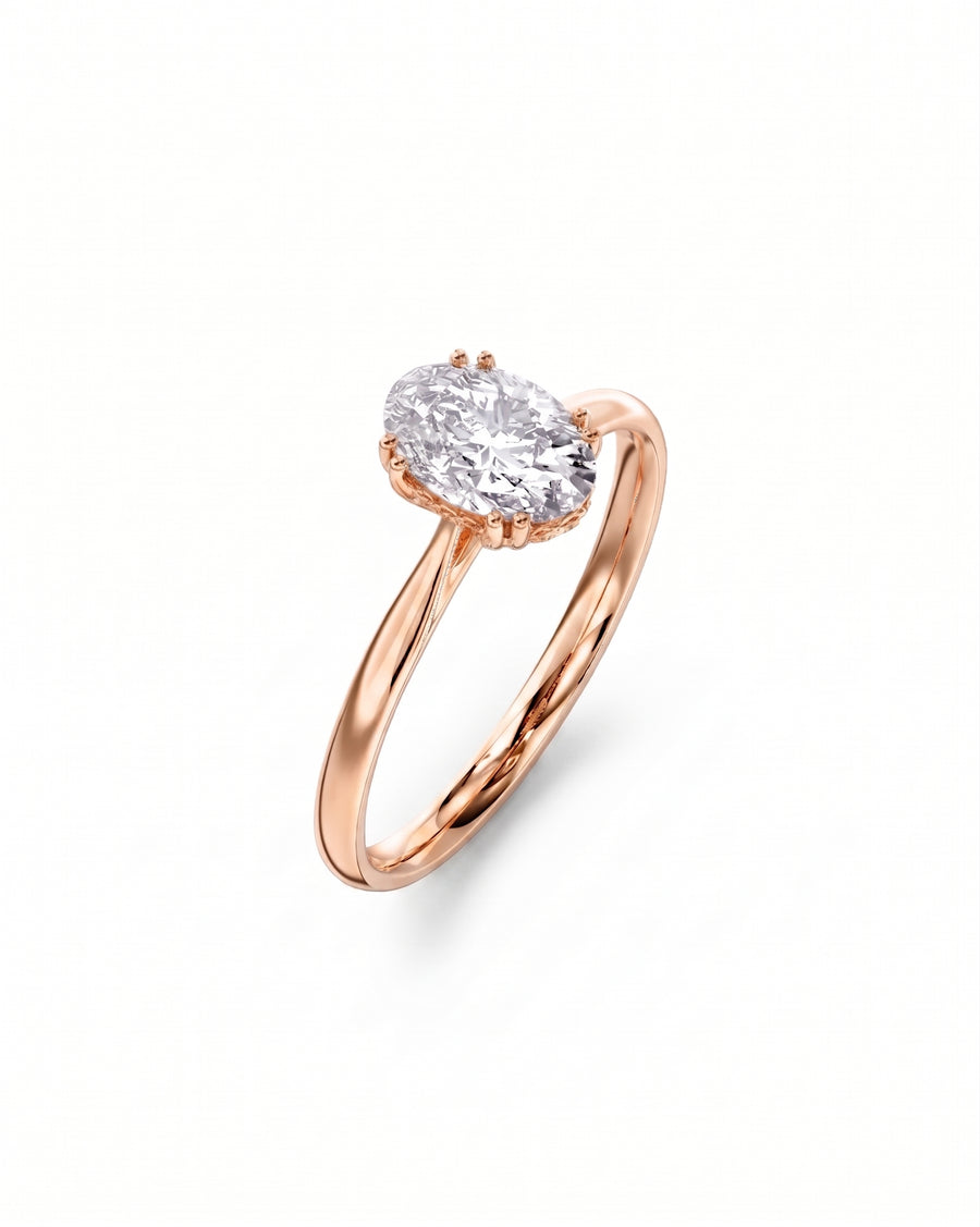 Rose gold engagement ring with an oval cut diamond and hidden halo.