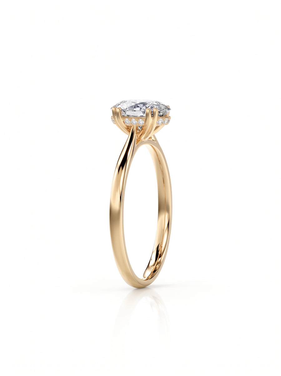 Oval cut diamond engagement ring with a hidden halo on a polished yellow gold band.