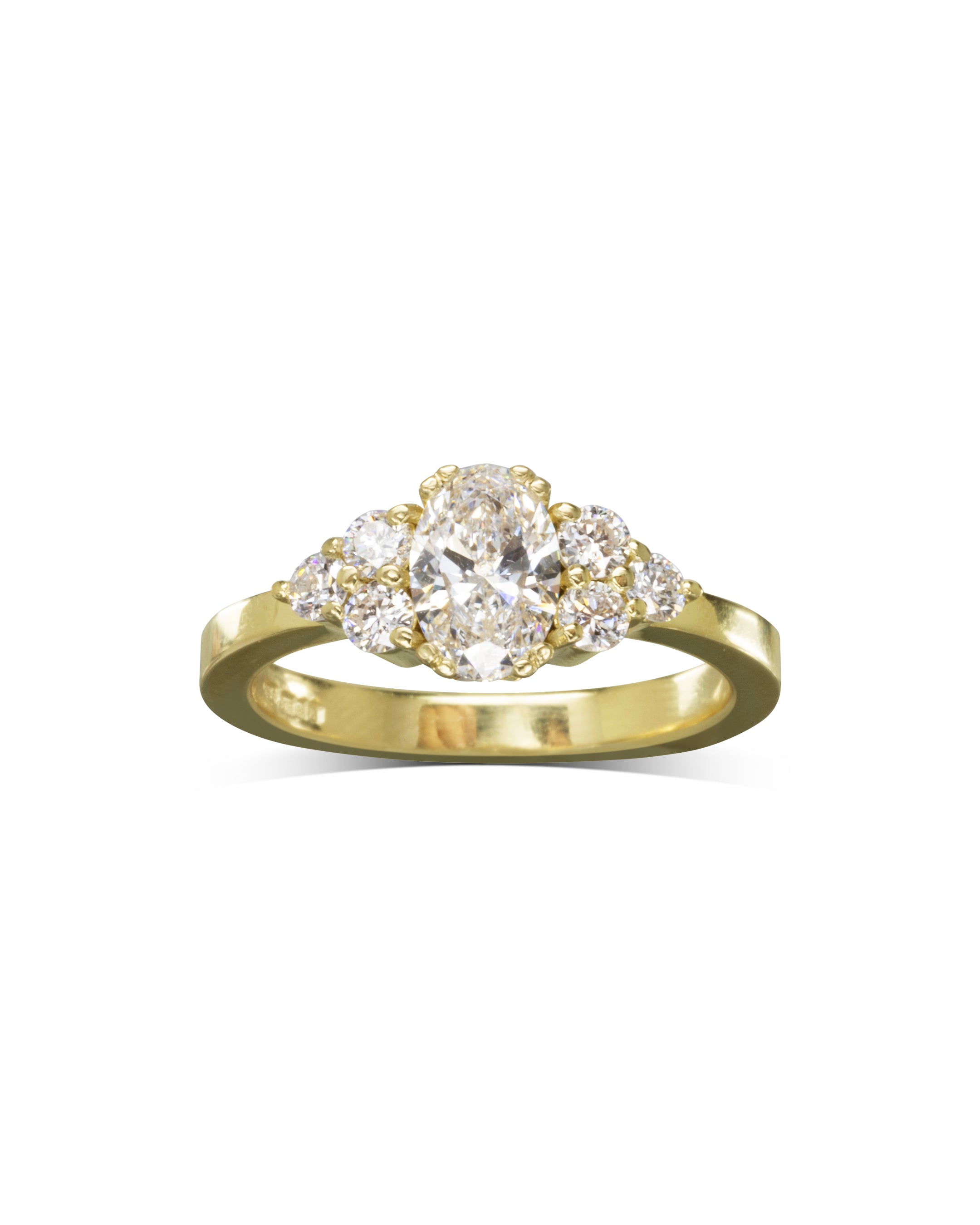 Gold engagement ring with an oval cut diamond center and six round diamonds.