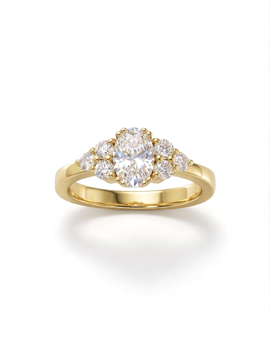 Gold oval cut diamond engagement ring with trefoil claw setting.