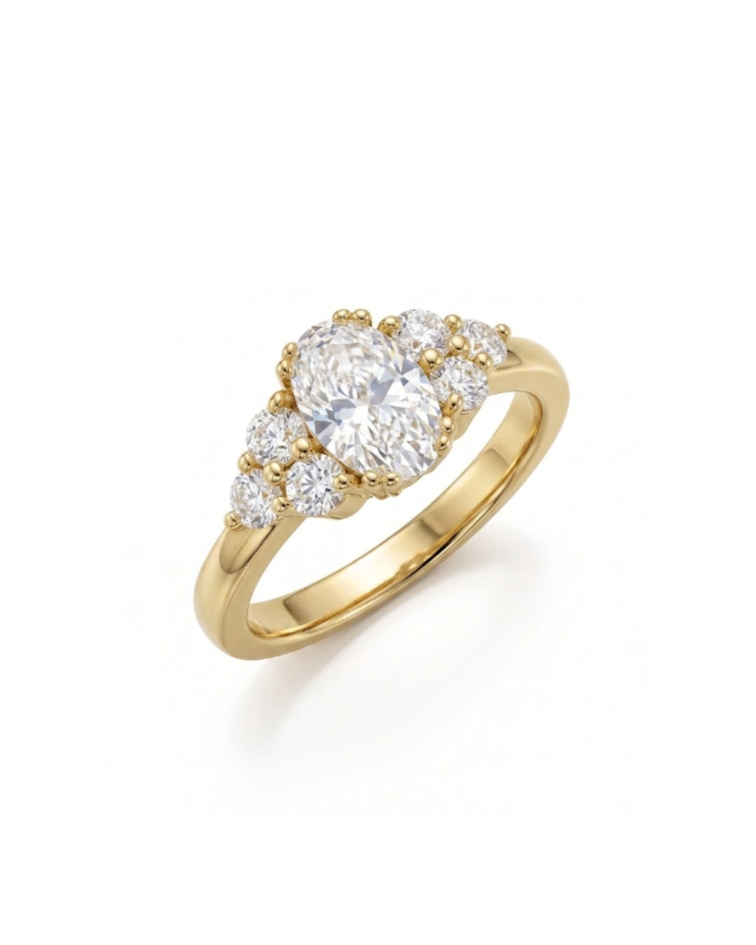 yellow Gold engagement ring with an oval cut diamond center stone and six round side diamonds.