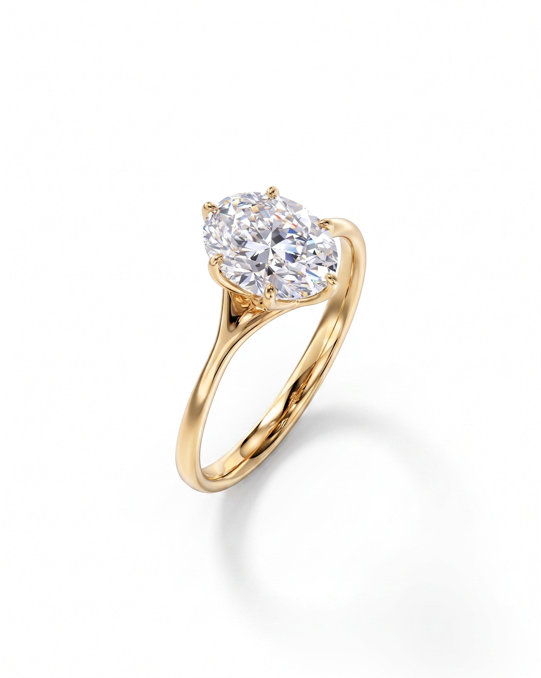 Yellow gold engagement ring with an oval cut diamond in a tulip claw setting.