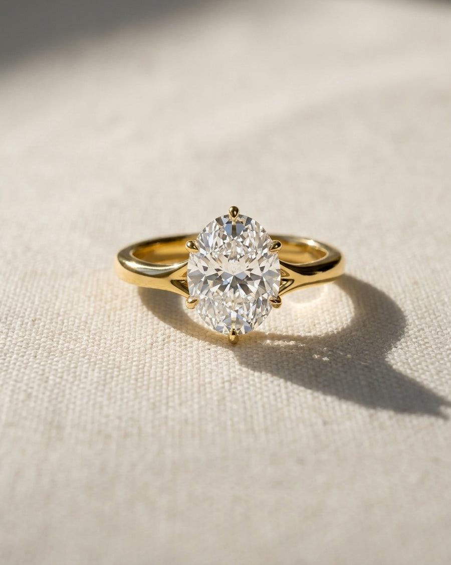 Oval cut diamond engagement ring in 18ct yellow gold with a tulip claw setting.
