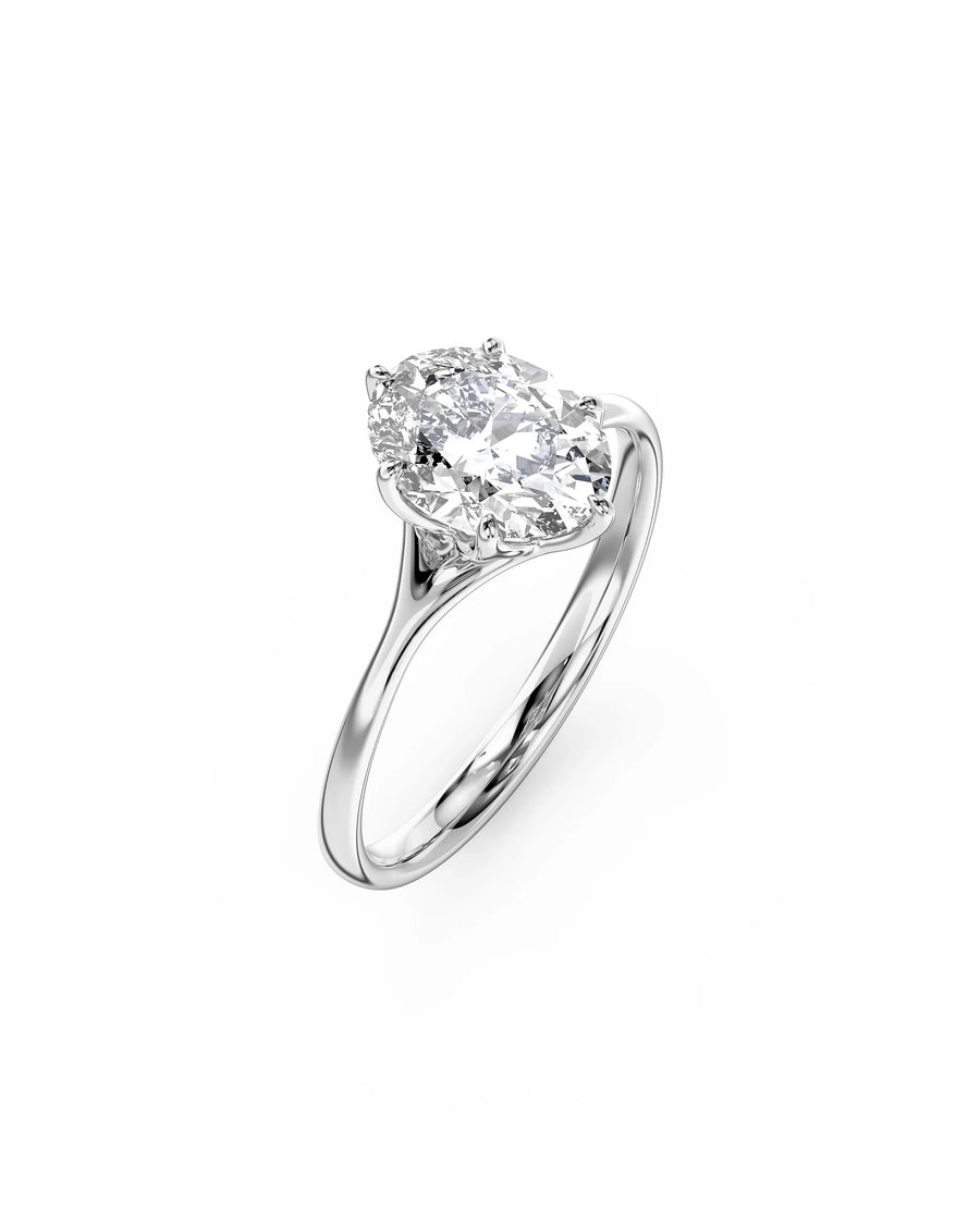 Oval cut diamond engagement ring in a platinum tulip claw setting on a polished silver band.