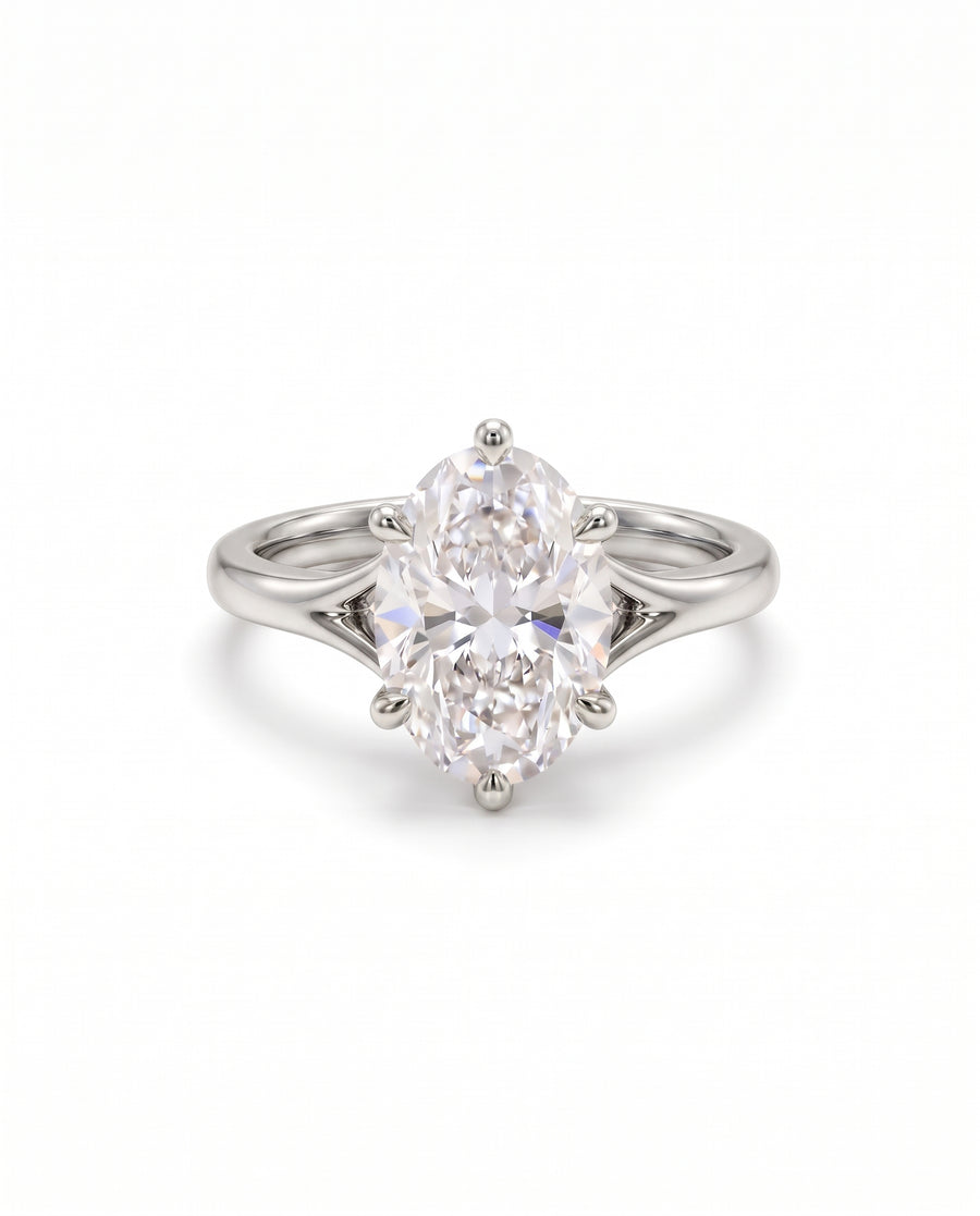 Oval cut diamond engagement ring in platinum with a six-prong tulip claw setting on a split shank band.