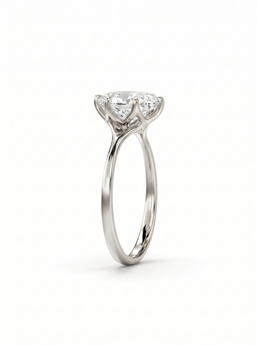 Oval cut diamond engagement ring in polished white gold with a tulip-style claw setting.