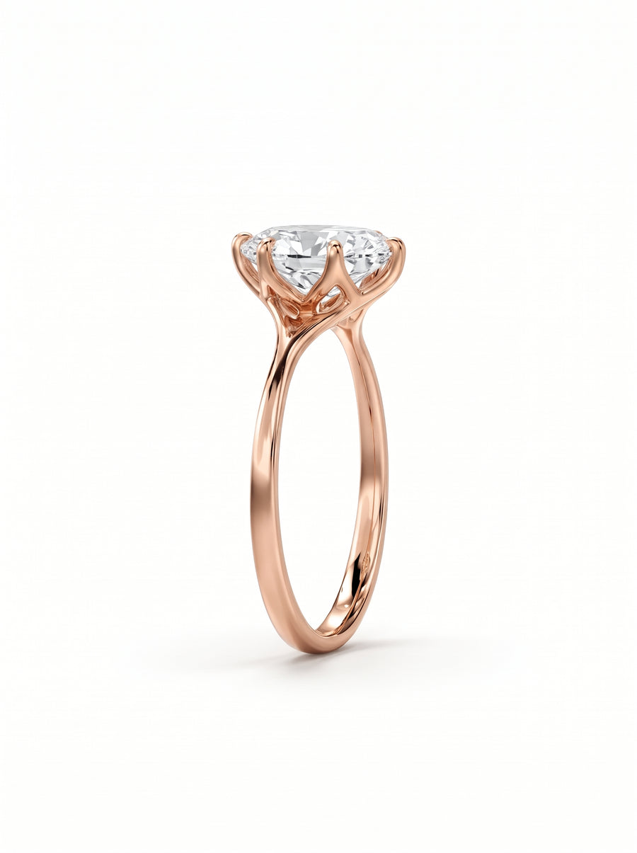 Oval cut diamond engagement ring in rose gold with a tulip-shaped claw setting.