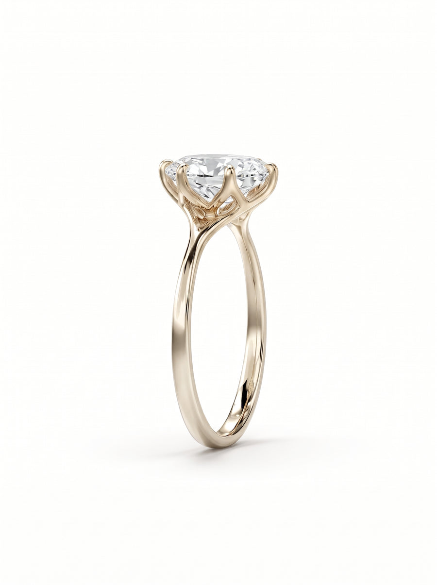 Oval cut diamond engagement ring in yellow gold with a tulip-style claw setting.