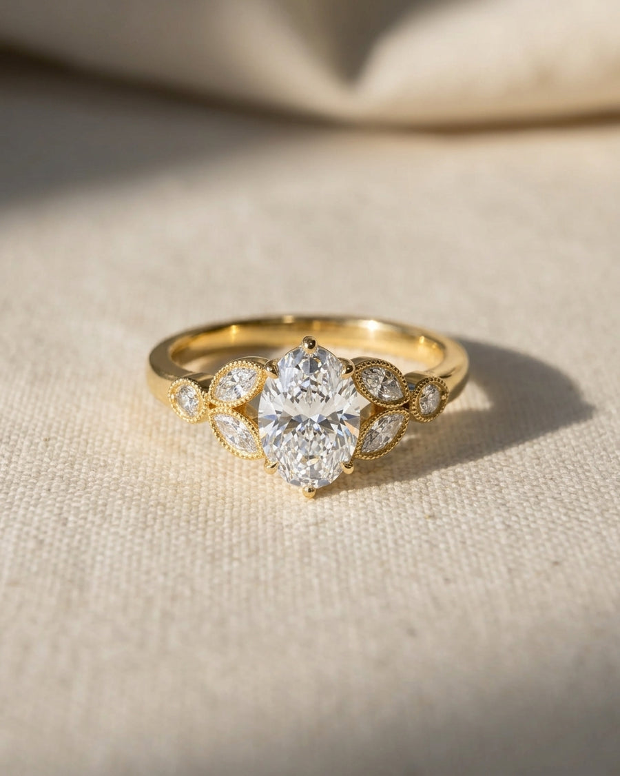 18ct yellow gold engagement ring with a 1ct oval lab grown diamond and marquise accents.