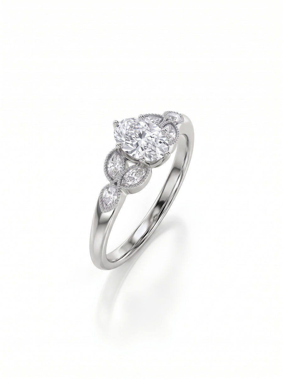 Oval cut diamond engagement ring in silver metal with marquise side stones and milgrain detailing.