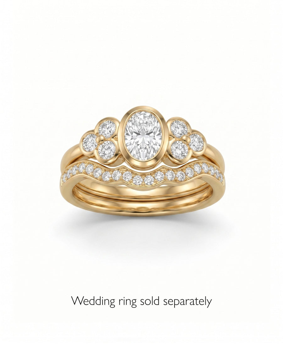 Gold oval trefoil engagement ring with diamond accents.