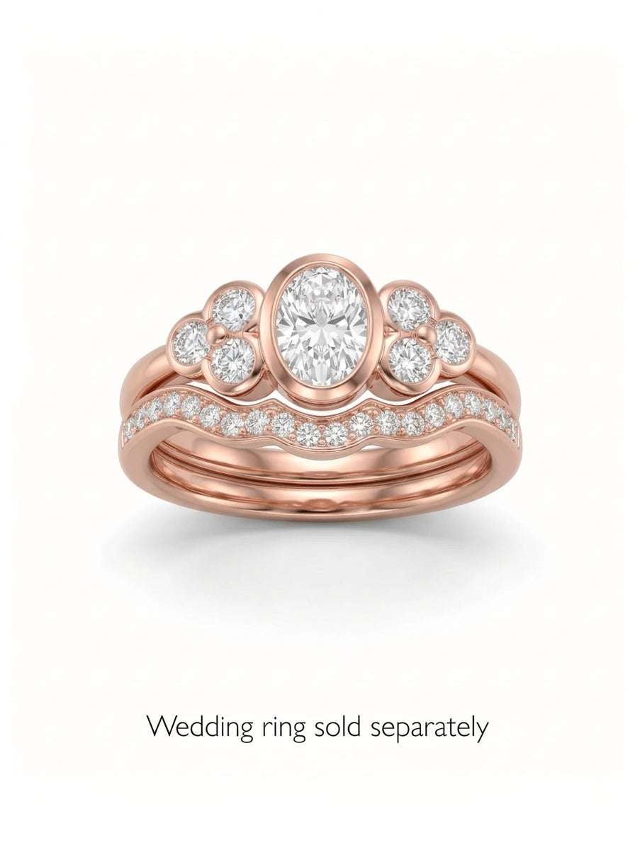 Rose gold oval trefoil engagement ring with diamond accents and a matching curved diamond wedding band.