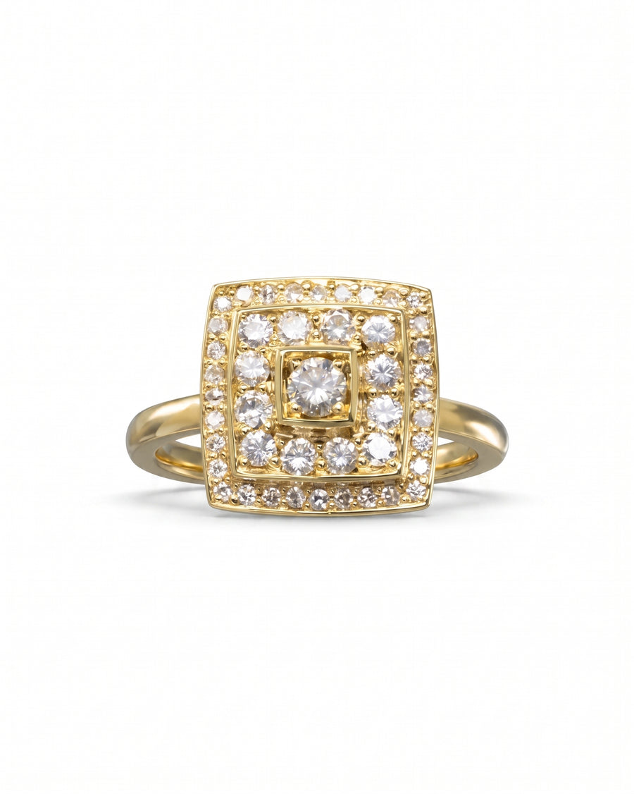 Gold cluster engagement ring with a square diamond halo design.