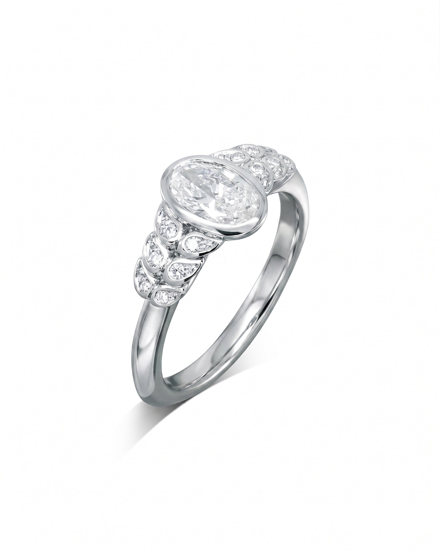 White gold engagement ring with an oval diamond and paisley-shaped side diamonds.