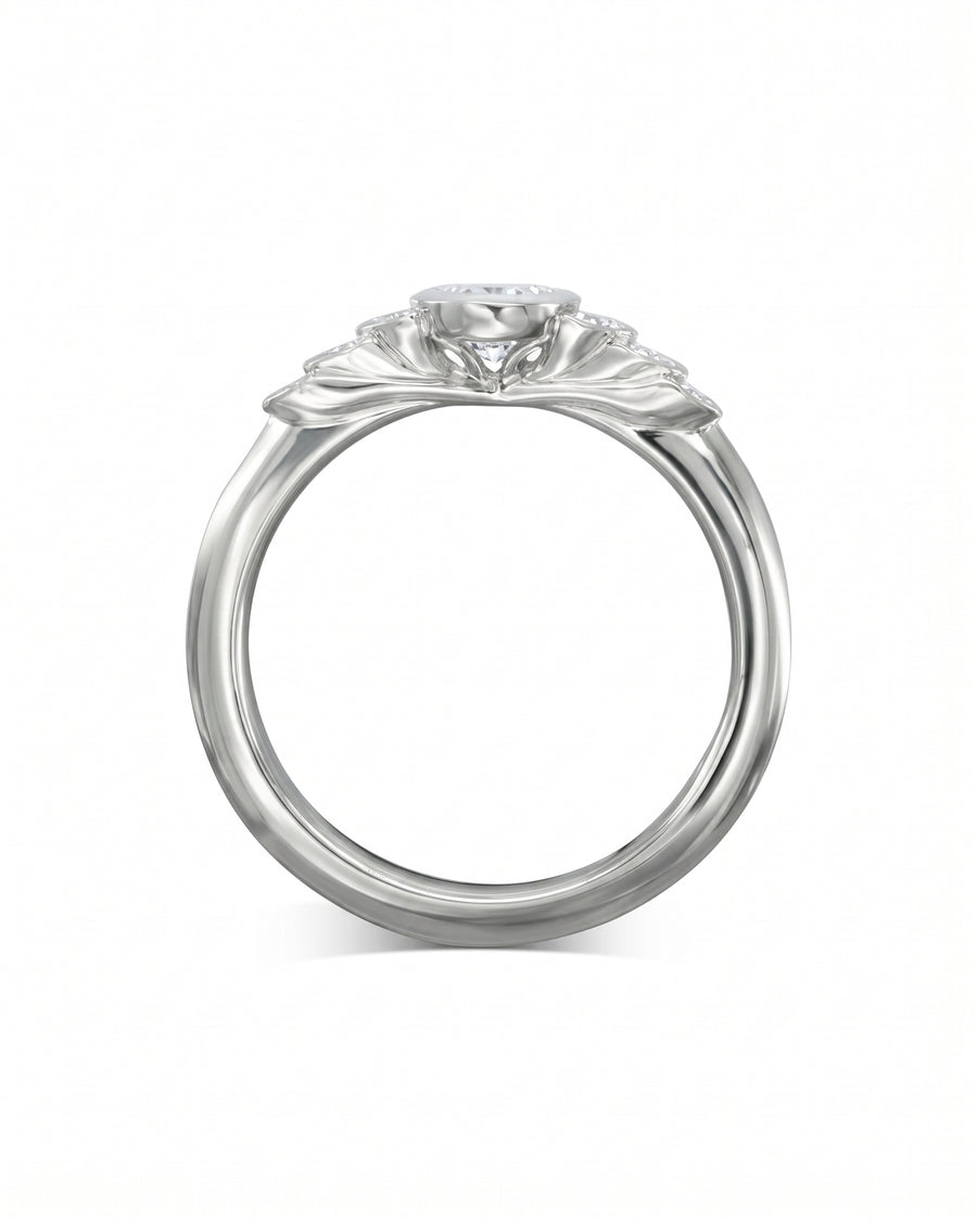 White gold engagement ring with a round diamond and paisley-inspired design.