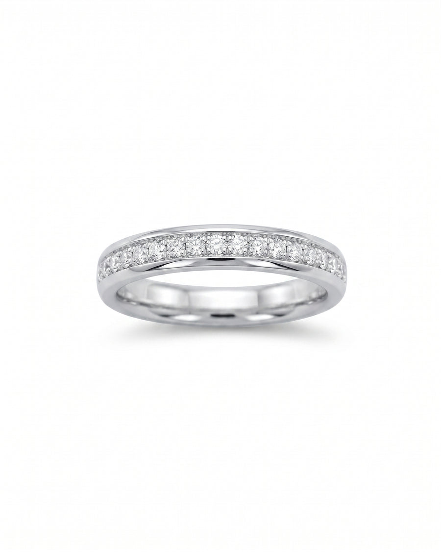 Pavé diamond platinum ring with a single row of round diamonds.