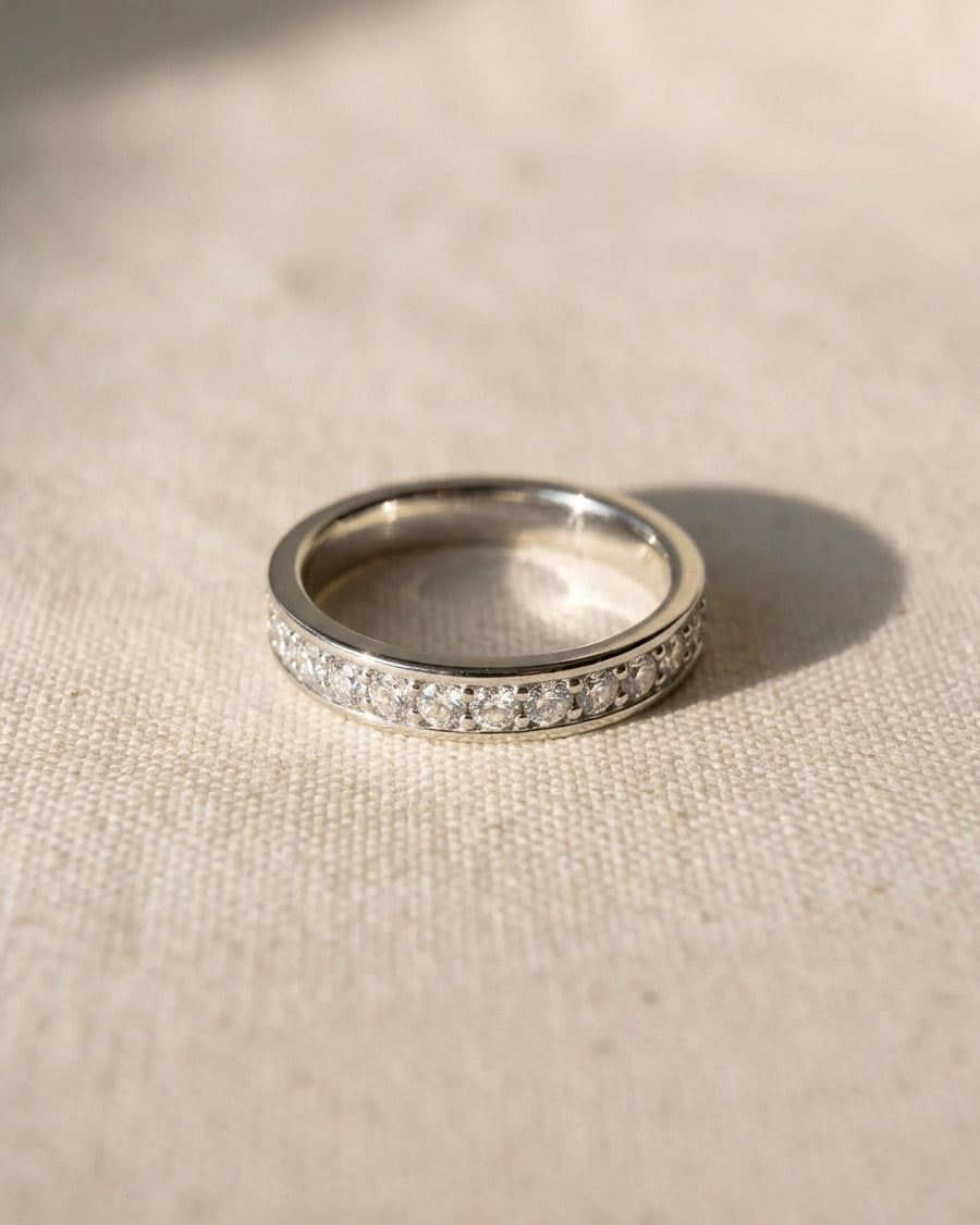 Platinum pavé diamond ring with a row of round diamonds.