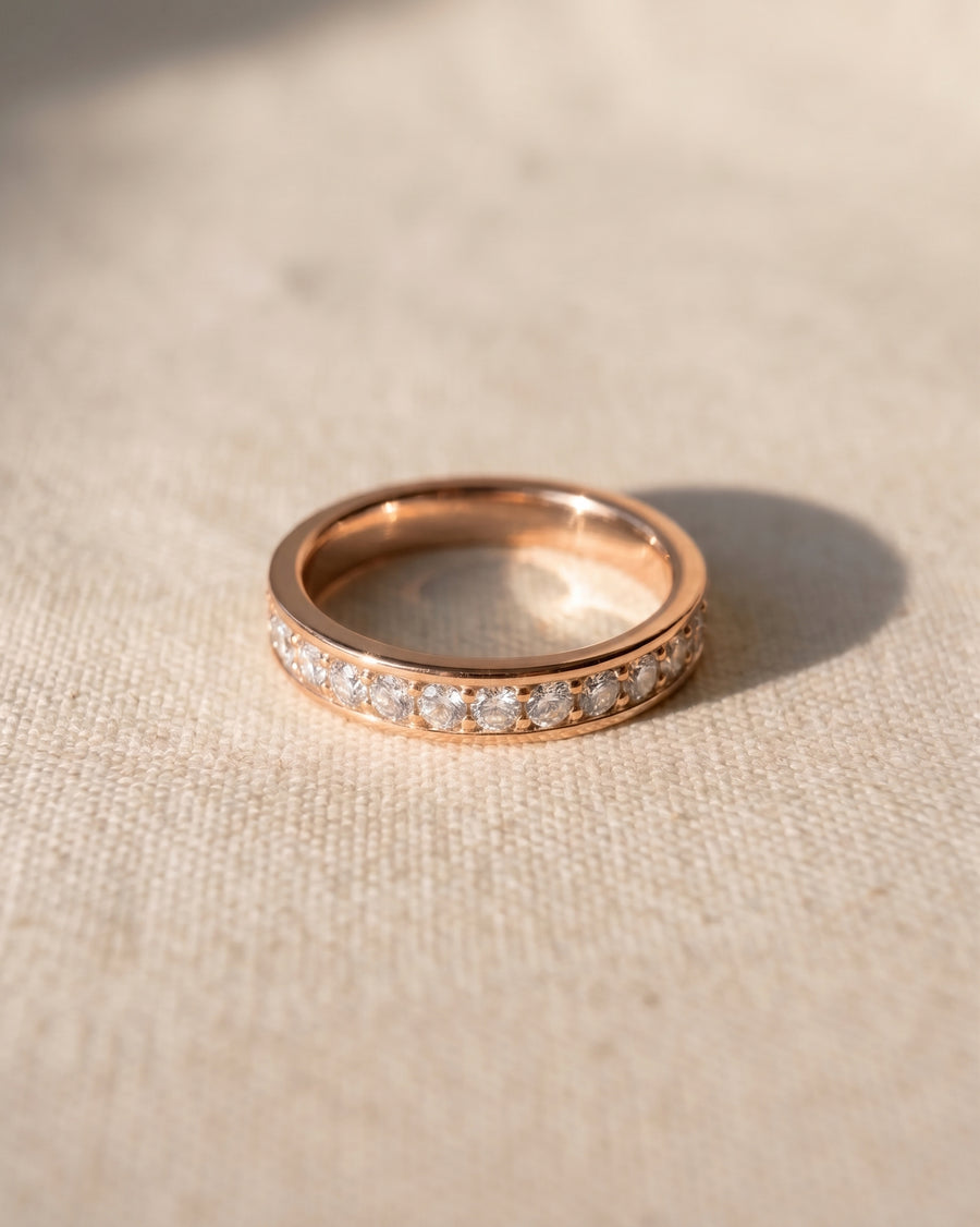 Rose gold ring with a pavé diamond band.