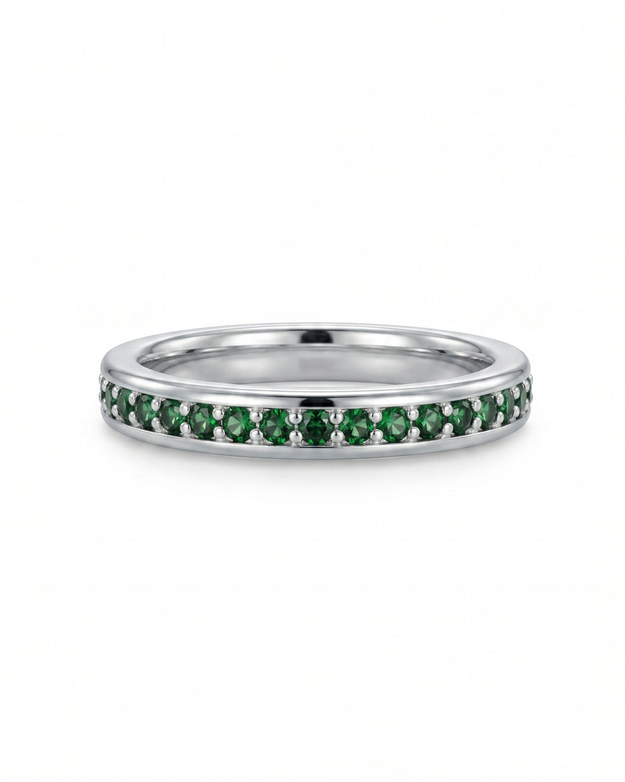 Platinum ring with pavé set round green diamonds.
