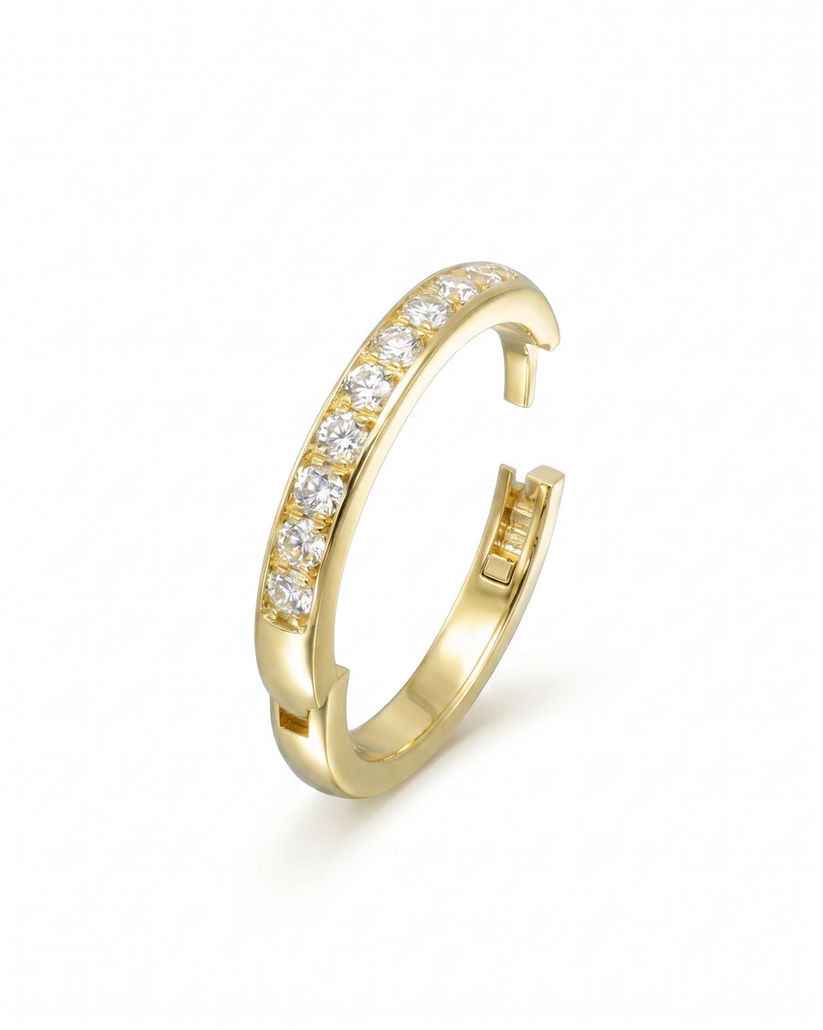 Gold pavé hinged ring with a row of clear gemstones.